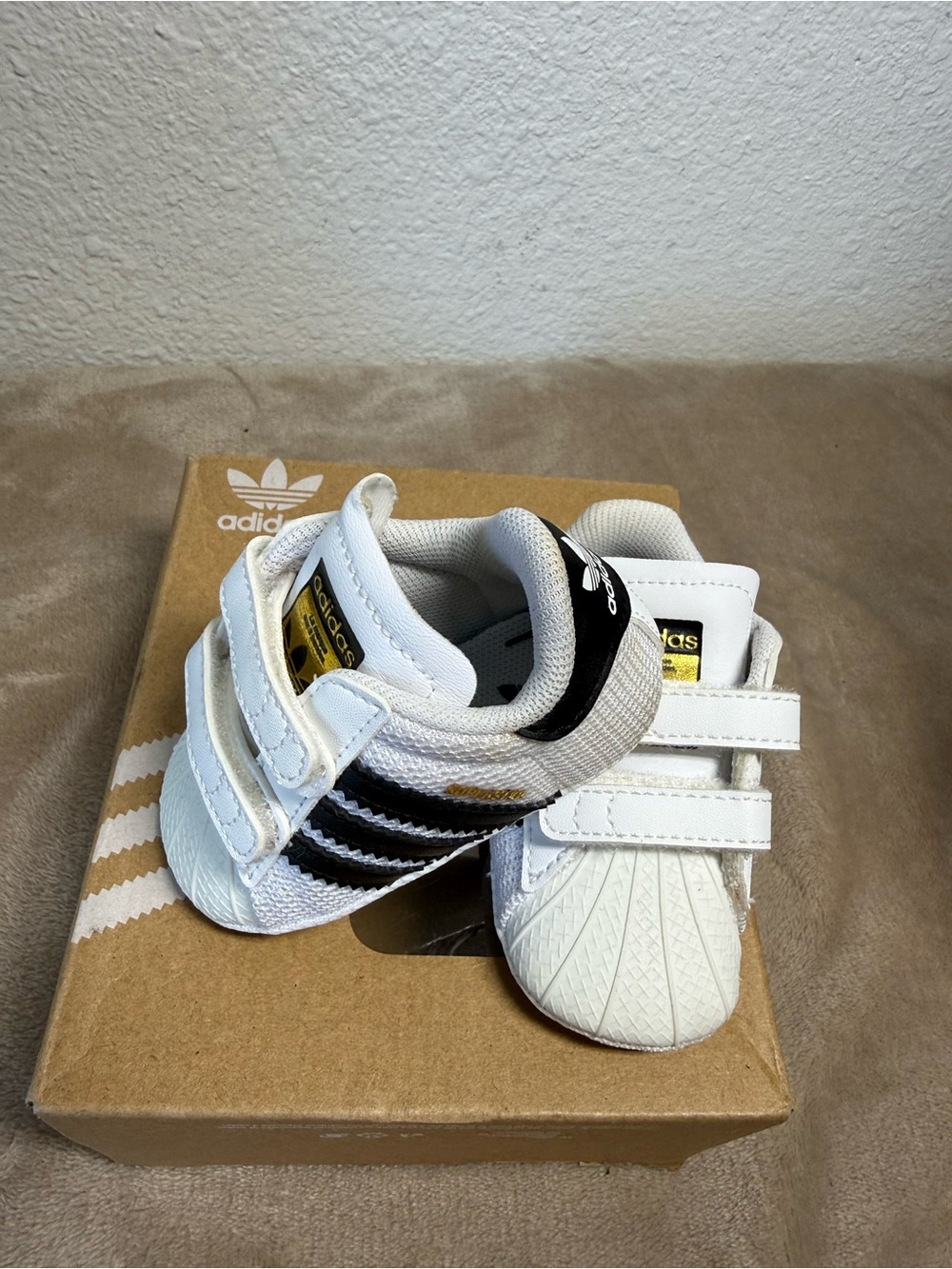 Adidas Superstar Crib shoes in Cloud White and Core Black